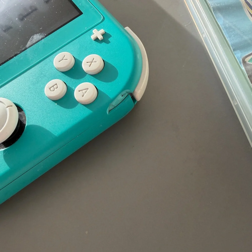 Teal Nintendo Switch Lite with Pokémon Sword